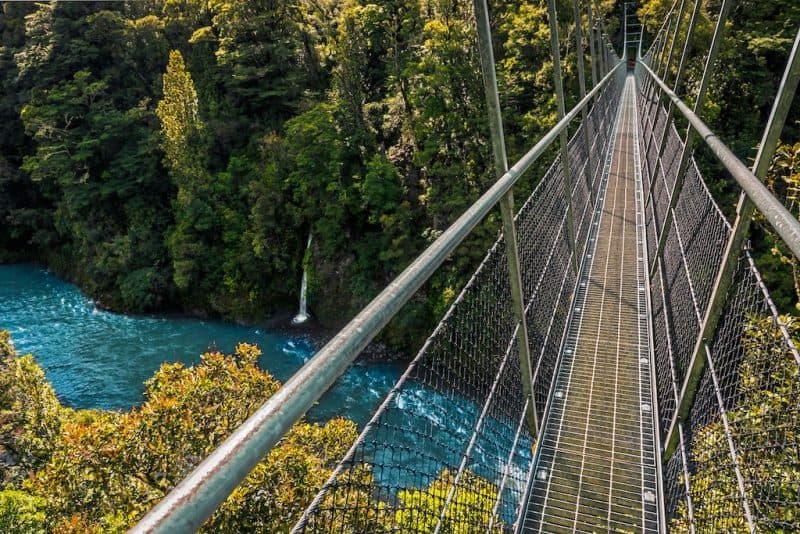 2 WAIRARAPA WALKS WITH INCREDIBLE VIEWS [NEW ZEALAND], gray suspension bridge over blue waters in autumn